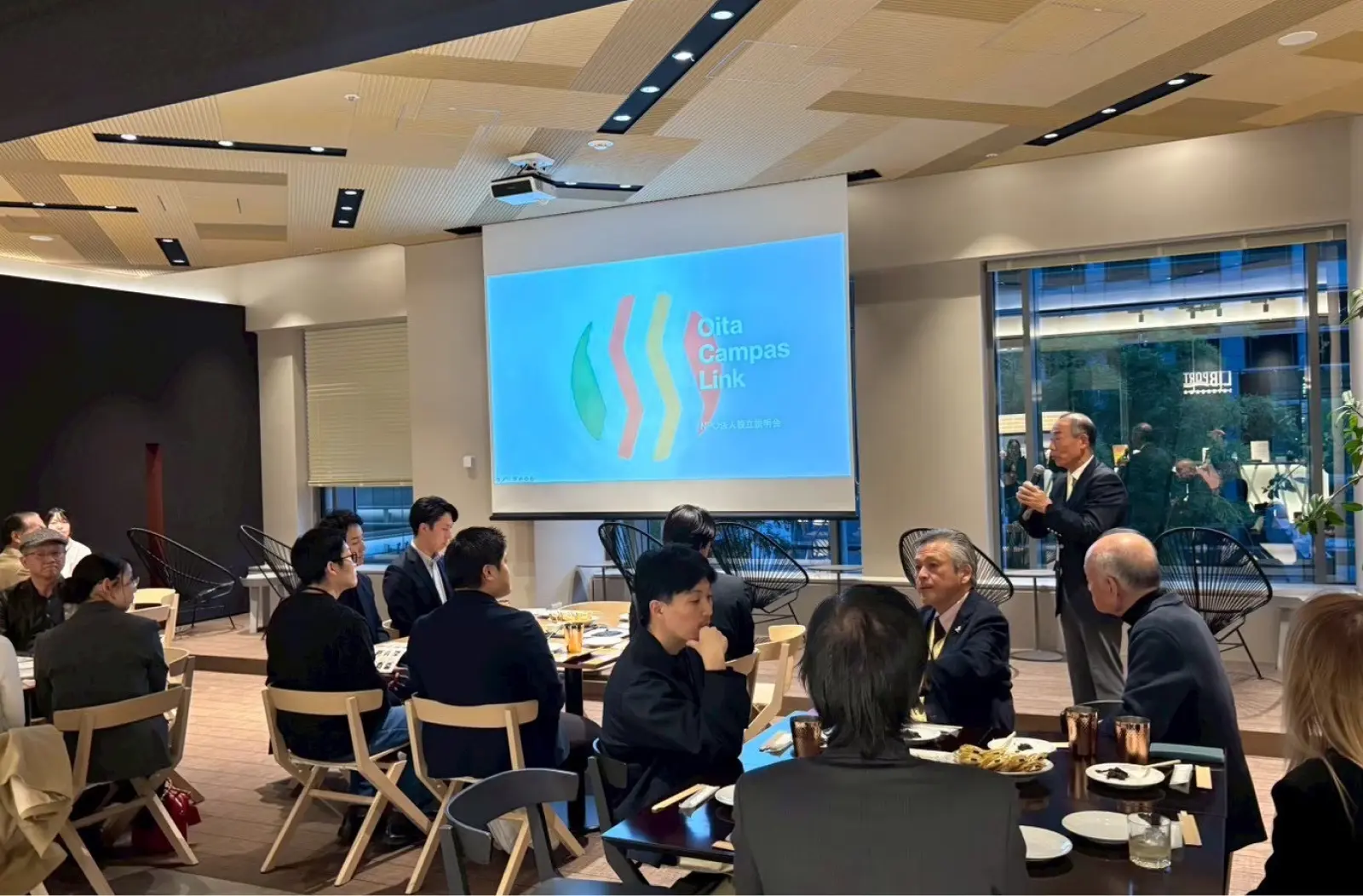 交流会で挨拶をする社会人出席者